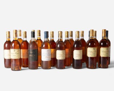 several bottles of wine are lined up in a row on a white surface