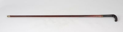 a close up of a cane with a handle on a white surface