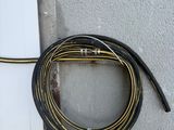 a black hose attached to a wall next to a white door