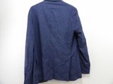 the back of a blue jacket hanging on a white wall