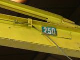 a close up of a yellow crane with a number plate on it