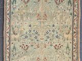 an antique persian rug with a floral design and fringe fringes