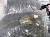 a pile of clothing wrapped in plastic on the ground