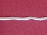 a silver sword on a red surface with a gold handle