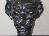 statue of a man ' s head with a goat ' s head in the middle