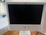 an apple desktop computer sitting on top of a wooden desk