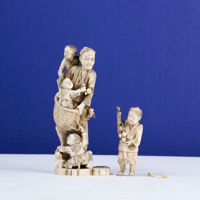 two figurines of a man and a child on a table