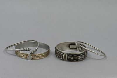 pair of silver and gold rings on a white background