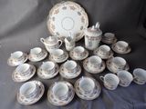 many cups and saucers that are sitting on a table