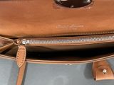 a close up of a brown purse with a zipper on it
