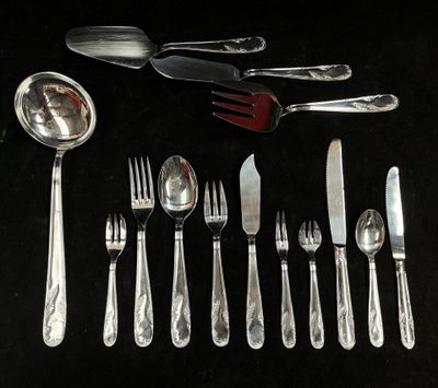 a lot of silver spoons and forks on the table