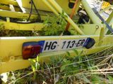 a close up of a yellow trailer with a number plate on it