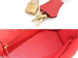 two pictures of a red purse with a lock on it
