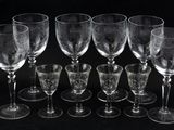 six empty wine glasses sitting next to each other on a black surface