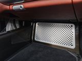 the interior of a car with the door open and a speaker in the center