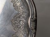 a silver plate with a decorative design on it