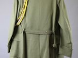 an army green jacket with a gold chain on a hanger