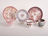 many different types of plates and cups on the table