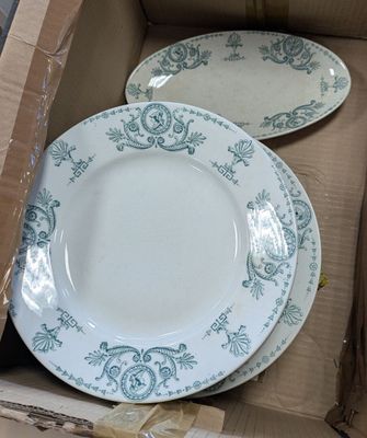 two plates in a box that are sitting on top of each other
