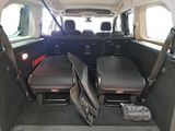 two seats in the back of a van with the door open