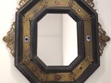 a black and gold frame with a blue eye on it