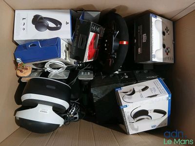 a cardboard box filled with electronic gadgets and headphones