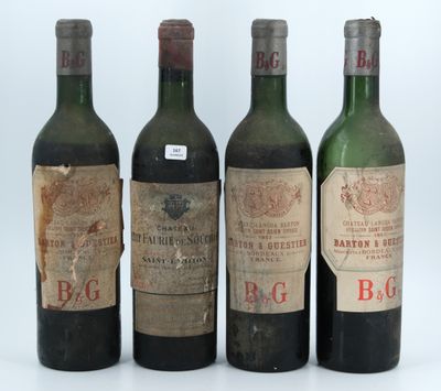 four bottles of wine are lined up in a row on a table