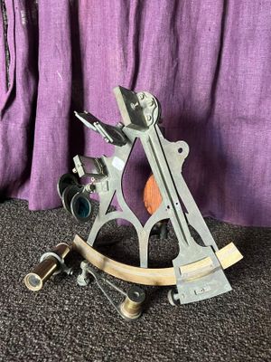 a metal sexage with a wooden handle on the floor