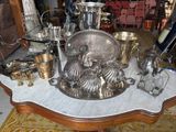 a table that has a lot of silver items on it