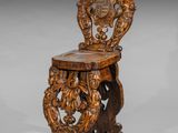 an old wooden chair with a carved back and seat