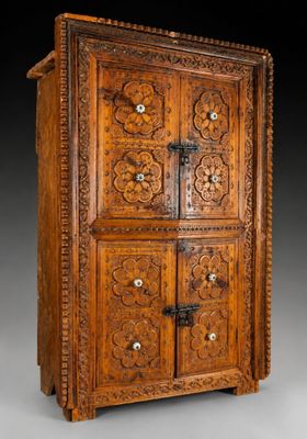 an old wooden cabinet with carvings on the doors and drawers