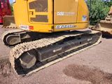 a large yellow bulldozer parked in a parking lot