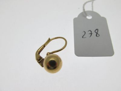 a small gold ball on a hook next to a price tag