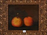 painting of two apples in a gold frame on a black background