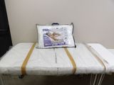 a bed with a pillow on top of it and a pillow on top of it