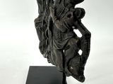 statue of a man riding a horse on a black base