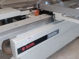 a machine that is cutting a piece of wood