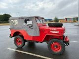 a red jeep that is parked in a parking lot