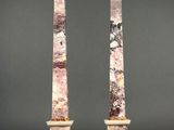 a pair of pink marble obelisks on marble bases
