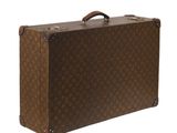 une image représentant une valise marron sur fond blanc