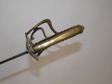 a metal object with a handle on a white surface