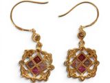 gold plated earrings with pink stones on them on a white background