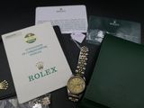 a watch and a wallet sitting on a table