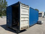 a blue shipping container sitting in the middle of a parking lot