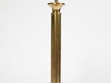 a brass table lamp on a white background with a cord