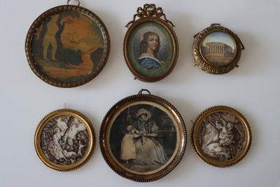 five framed pictures of people on the wall