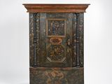 an old wooden cabinet with a decorative design on the door