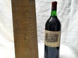 a bottle of wine sitting next to a wooden box