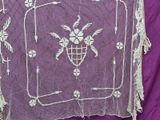 a purple table cloth with a white design on it