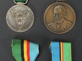 several medals are displayed on a black surface with a black background